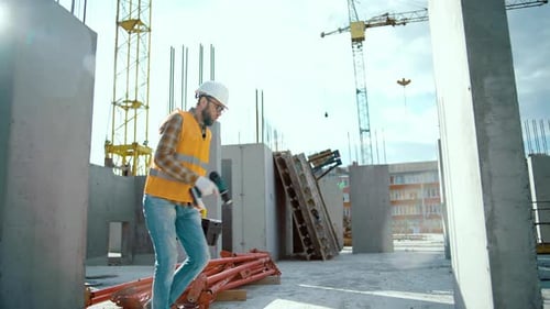 Construction Worker Walking on Construction Site