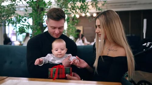 Family with Baby Celebrates Birthday at Restaurant