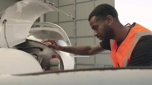Aircraft Maintenance Engineer Inspecting Engine in Slow Motion