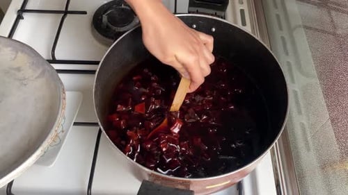 Slow Food, zu Hause kochen, roten Sirup für süße Quittenmarmelade umrühren und mischen, um die Fruchtscheiben zuzubereiten.