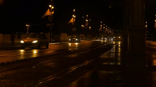 Tram Crossing Along Road at Night