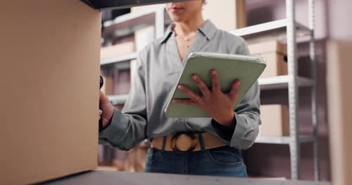 Woman Scanning Boxes with Barcode Scanner in Warehouse