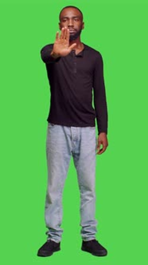 Vertical Video Front View of Negative Person Raising Hand Doing Stop Sign on Camera