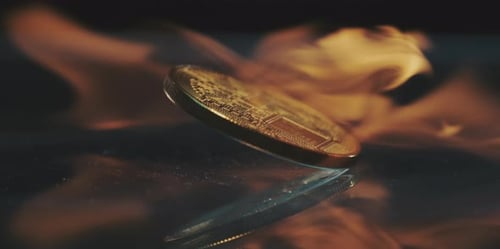 Gold Crypto Coin on Fire Close Up