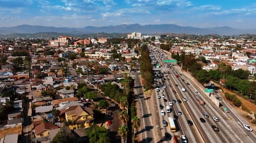 Streets and roads of Los Angeles filled with multiple cars. Busy lifestyle of metropolis at daytime
