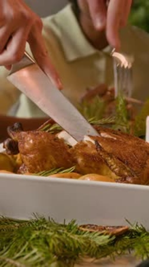 Vertical of Anonymous Man Carefully Cutting Roasted Turkey during Festive Dinner