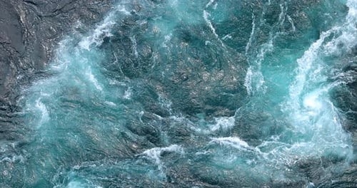 Blue waves of water of the river and the sea meet each other during high tide and low tide.