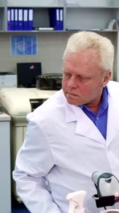 Man in Lab Coat Standing in a Lab