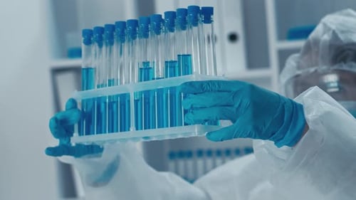 Medical Researcher Examining Test Tubes in Lab