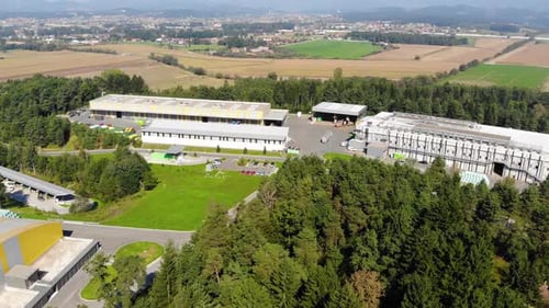 Large industrial plastic recycling plant in eastern Europe countryside, Aerial flyover shot