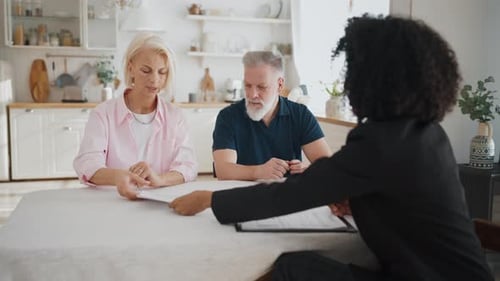 Senior Married Couple Discussing Sale or Buy of Real Estate with Female Agent Elderly Man and Woman