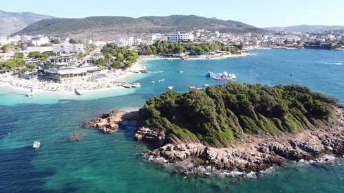 Aerial Drone View of Ksamil Beach, Ionian Sea, Albania - Island, Sunbeds, Boats, Hotels, Resorts, Mo