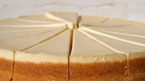 Plain Cheesecake Cake Closeup Spinning on Turntable Cakes in a Coffee Shop Many Slices of Classical