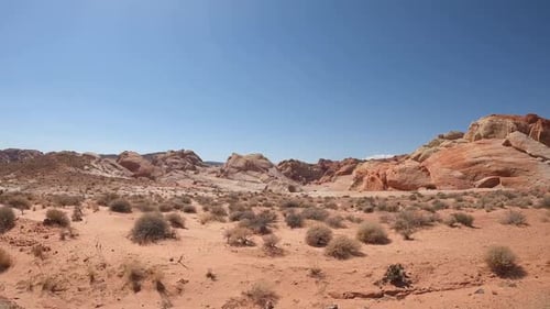 Vast Desert Landscape Featuring Unique Sandstone Formations And Red Rocks