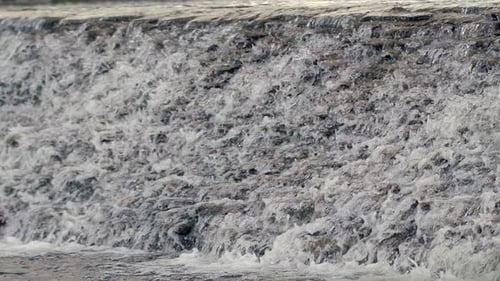 Water Flowing Over Stone Cascade. River Waterfall in . Closeup Of