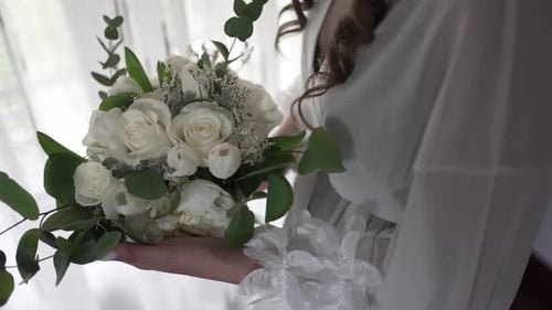 Bride Holds White Rose Wedding Bouquet Indoors