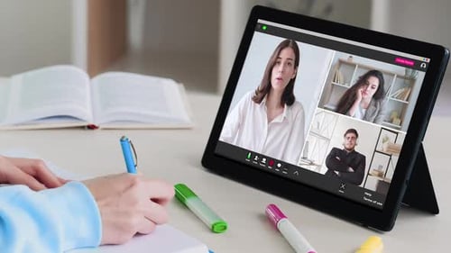 Student Taking Notes During Virtual Online Meeting