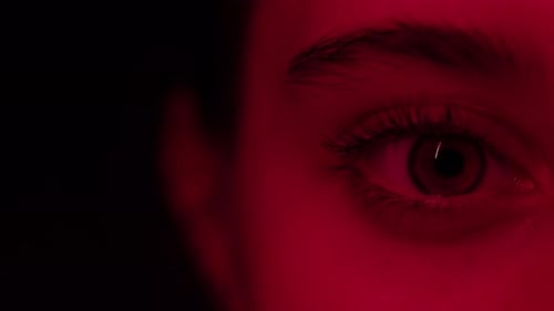 Extreme Close Up of an Eye in Red Light
