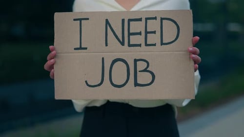Hands of the Caucasian Businesswoman Holding Poster Cardboard with Need Job Jobless Message