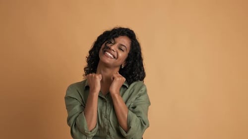 Smiling Woman with Curly Hair Posing in Studio