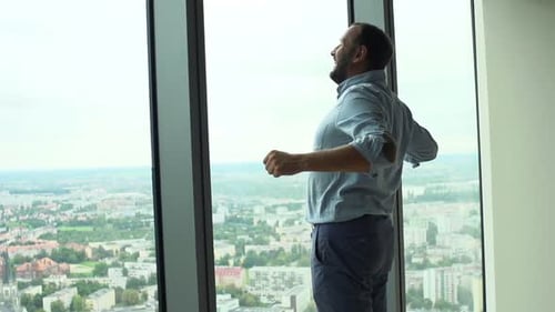 Man Stretching Arms and Admire View From Window at Home Super Slow