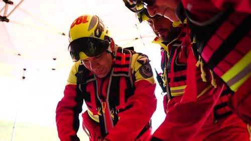 Adults in Suits Look at Map Under Tent