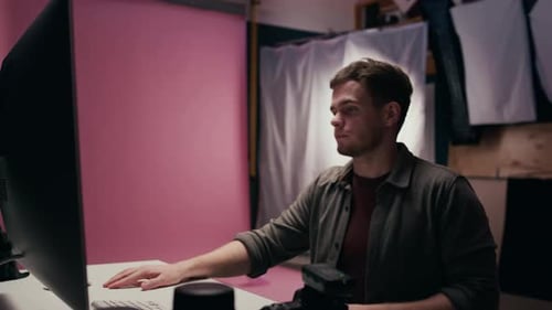 Digital Photographer Working on Computer in Professional Photo Studio