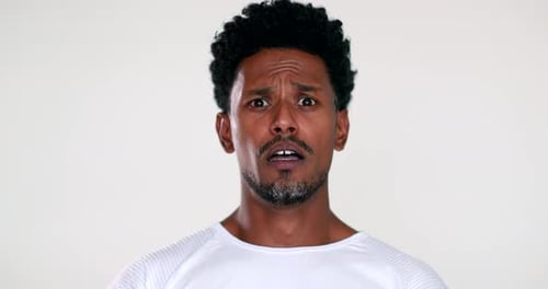 African man reacting with terror and horror to camera, black guy shock reaction