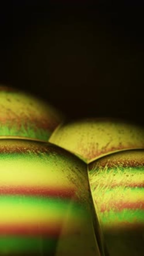 Soap Bubbles In Yellow, Green, And Orange Colors