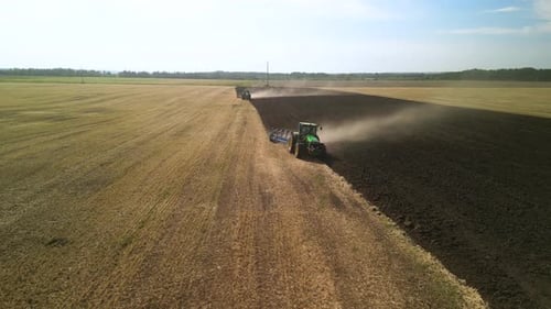 Tractors plowing the field in Ukraine