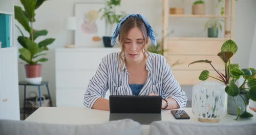 Young Woman Uses Tablet Device at Home