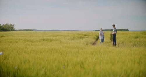 Farmers Talking In Field Discussion Examining Crops Agriculture Concept