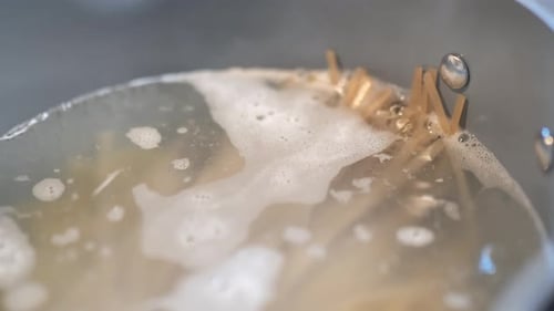 Close up of pasta noodles in boiling water.