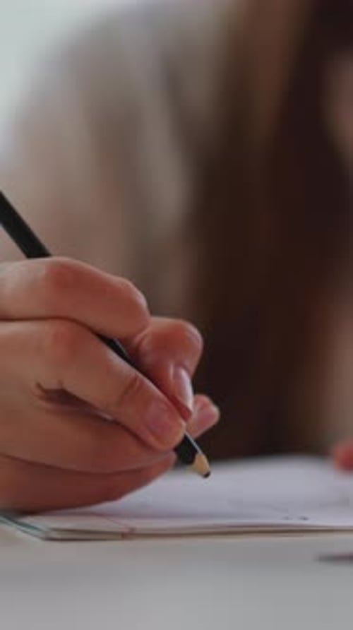 Young Adult Drawing Intricate Details on Paper