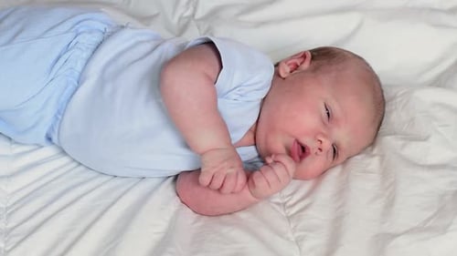 Adorable Infant Lying on Blanket Awake Close Up
