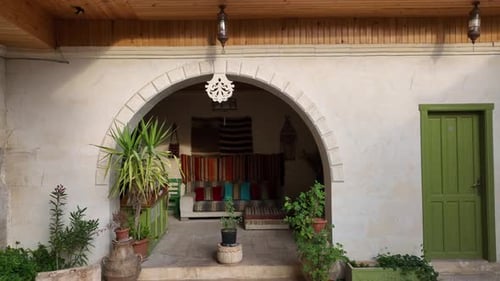 Aerial Shot of a White Stone Home with Green Doors