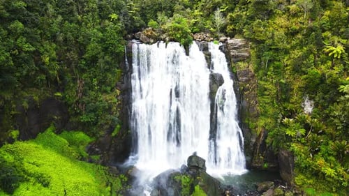 Drone moving towards a waterfall at high rocky cliff. 4K videos.