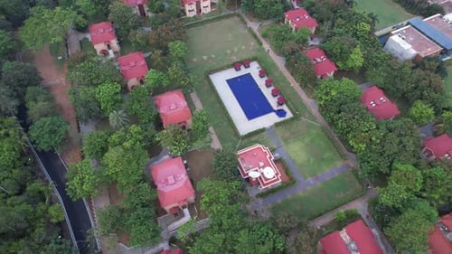 A drone footage of the pool at an opulent resort. Residential properties and villas.