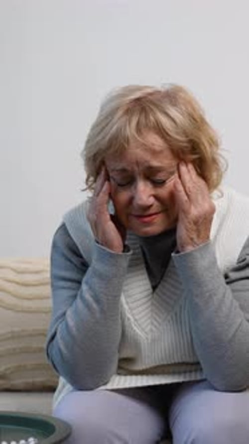 Senior Woman Experiencing Headache Pain at Home