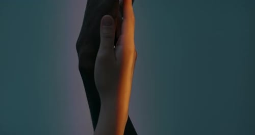 Intimate Hands Intertwined in Sunlight
