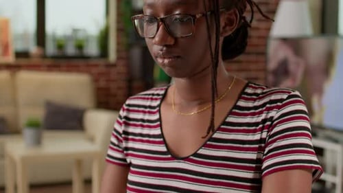 Woman working on laptop computer in home office