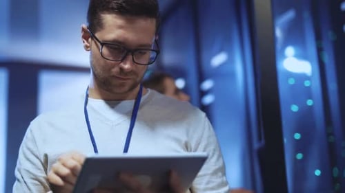 IT Specialist Uses Tablet in Server Room