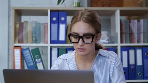 Portrait of Smart Young Woman Executive Using Modern Laptop Computer Looking on Screen Working in