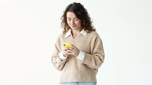 Smiling Woman Using Smartphone Indoors