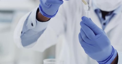 Scientist Carefully Dispensing Liquid into Test Tube