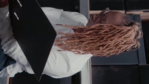 Adult Holds Clipboard in Workplace Vertical Video