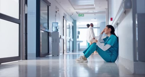 Doctor, headache and sad on floor for clinic mistake, healthcare fail or hospital death with stress