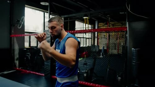 Male boxer training fit man doing boxing in gym young man doing warm up stretching muscles