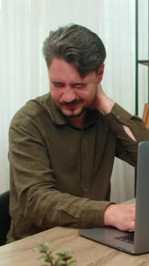 Man at Desk Massaging Stiff Neck