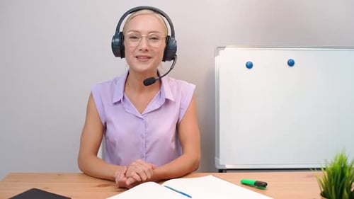 Woman With Headset Teaching at Desk